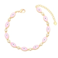 Detailed shot of pink evil eye bracelet with cubic zirconia and gold heart charm - Pink