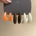Close-up of three pairs of acrylic C-shaped earrings in orange, brown, and white colors - 3-Pair Set: Orange/Brown/Beige