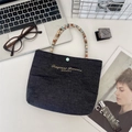 Mini navy denim tote bag with gold embroidery and colorful ring handles in a modern office setup - Light Blue-Brown Small