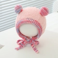 Dettaglio del cappello in peluche rosa per neonati con due pompon e paraorecchie - 1-3 Anni / Rosa