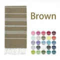 Brown striped Turkish beach towel detail with white tassels and multiple color swatches - Brown