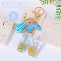 Ocean style resin letter N keychain with sand, starfish, and blue leather tassel - Letter N