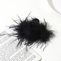 Detail shot of fluffy black ostrich feather hair claw clip on an open book background - 11cm Black Ostrich Feather Claw Clip