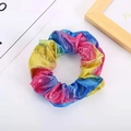 Macro detail of rainbow gradient metallic hair scrunchie with shiny textured fabric - Rainbow Holographic