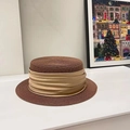 Macro view of brown straw flat top hat with pleated gold satin ribbon decoration - Coffee/Gold Ribbon