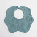 Detail showing the snap fastener and ripple texture of the blue cotton baby bib - Teal