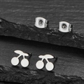 Polished stainless steel cherry stud earrings for women on a dark textured stone background - Silver Cherry