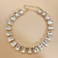 Rectangle clear crystal choker necklace with golden metal setting on beige background - White Zirconia