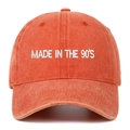 Detail of embroidered 'MADE IN THE 90'S' text on washed vintage orange baseball cap - Orange