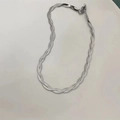 Elegant silver woven snake chain necklace featuring a triple-strand braided metal design - Double-strand Necklace / Silver