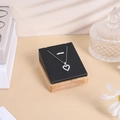 Detail of heart pendant necklace on black velvet stand with a premium wooden base - 7*8 Pendant Rack / Black Leather