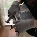 Detail of grey knitted gloves with black bow and touchscreen design for winter warmth - One Size / Gray