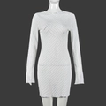 Macro detail of white long-sleeved dress showing textured lace and geometric knit pattern - S / White