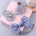 Detail of baby socks with mesh flowers and floral bow headband on gift display - Style 14 (Grey Sequin Star/Blue Purple Flower)