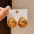 Close-up of vintage brown amber earrings with gold metallic finish held by hand - 54# Silver Earring Post - Gold/Brown