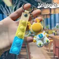 Süßer gelber Astronauten-Silikon-Schlüsselanhänger mit passendem Pop-it-Armband - Weltraumdrache Schlüsselanhänger / Gelb