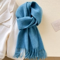Elegant blue pure wool scarf for women with tassels, neatly folded on a white coat - Peacock Blue Mix
