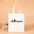 Detail of white canvas tote bag with black Groomsman text and bow tie hat icons - Style J (#Groomsman/Black/Hat)