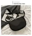 Detail of black nylon crossbody bag with adjustable strap and daisy flower charm accessory - Mini Shoe Charm Style / Black