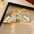 Elegant gold butterfly hair claw with pearl flowers and rhinestones on leather background - Exquisite Bowknot Tulip Pearl Claw