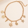 Gouden schakelketting met zeester, schelp en zonnehangers versierd met kristallen - Goud