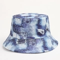 Close-up of retro 90s bucket hat featuring distressed denim print and bleach tie-dye detail - One Size (58cm) / Denim Look Tie Dye