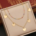 Golden double-layer necklace with colorful beads and multiple heart pendants on jewelry box - Heart Style
