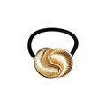 Detailed macro view of a minimalist golden shell-textured metal hair tie accessory - Radial Pattern Shell Ring