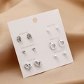 Detail of multi-style stud earring set with stars and pearls on weekday cards - Silver Heart Apple Star