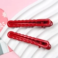 Close-up of red wavy edge hair clips with glossy finish on a minimalist display - 6cm length 2pcs set / Red