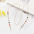 Golden alloy eyewear chain with colorful beads displayed on an elegant white book - Gold Alloy with Multi-color Beads (1)