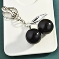 Sparkling black cherry keychain with silver metal leaves on a white tray display - Black