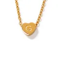 Detail of gold heart pendant with letter G engraving and fine necklace chain link - Letter-G