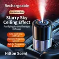 Black car aroma diffuser with starry sky projector and visible mist spray in vehicle - Rechargeable Starry Sky / Hilton Style