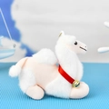 Close-up detail of a soft plush camel keychain featuring a red ribbon and golden bell - Bead Chain Style / White