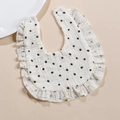 Detail of ruffled 4-layer cotton muslin baby bib with black polka dots and snap buttons - Black Polka Dot