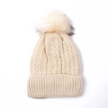 Close-up of beige cable knit beanie featuring a premium faux fur pompom and soft texture - Off White