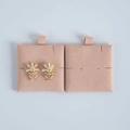 Close-up of pearl flower earrings with gold metal base on pink velvet display card - Nude Pink