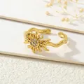 Close-up of wavy gold open ring featuring a zircon-studded sun and moon design - Gold Sun Moon