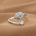 Retro evil eye open ring in silver with blue and clear zircons on brown fabric - Evil Eye Sunburst Style (Q-J082) / White Gold