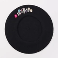 Close-up of black wool beret featuring colorful rhinestones and gemstone embellishments - One Size / Black