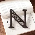 Industrial cast iron decorative letter N with rustic finish and mounting screws - Letter N
