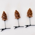 Three artificial pine cone hair clips with spring base on white background - Pine Cone Hair Clips (Pack of 3)