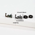Macro view of black steel Love letter studs with size dimensions and butterfly backings - Love (064) / Black