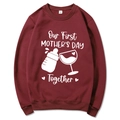 Maroon Mother's Day hoodie with 'Our First Mother's Day Together' text and graphics - Burgundy