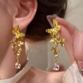 Elegant gold butterfly dangle earrings with teardrop zircon crystals on model - Butterfly Teardrop Dangle