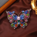 Vintage oversized butterfly brooch with colorful rhinestones on a textured background - Multi-color
