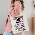 Detail of Witchy Mama Halloween canvas tote bag showing printed leopard smiley face - Witchy Mama