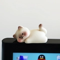 Mini resin cat ornament in white and brown, lying on a computer monitor edge - Type B Lying Cat