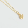 Minimalist gold necklace featuring a letter U pendant with textured dot pattern - Letter U